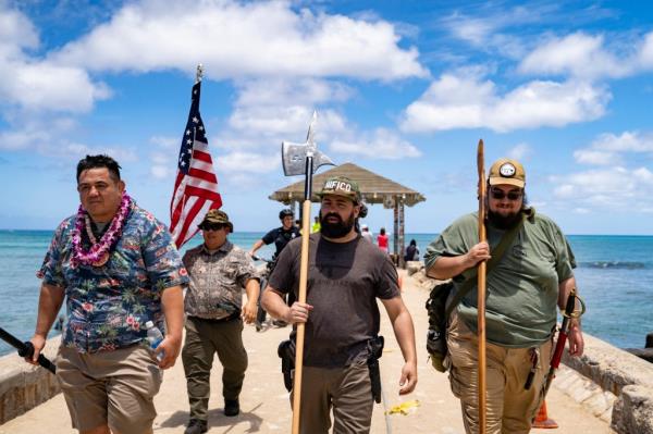 Members of Hawaii Firearms Coalition walk around Waikiki with their non-firearm weapons on Saturday, June 22, 2024, in Honolulu, Hawaii.